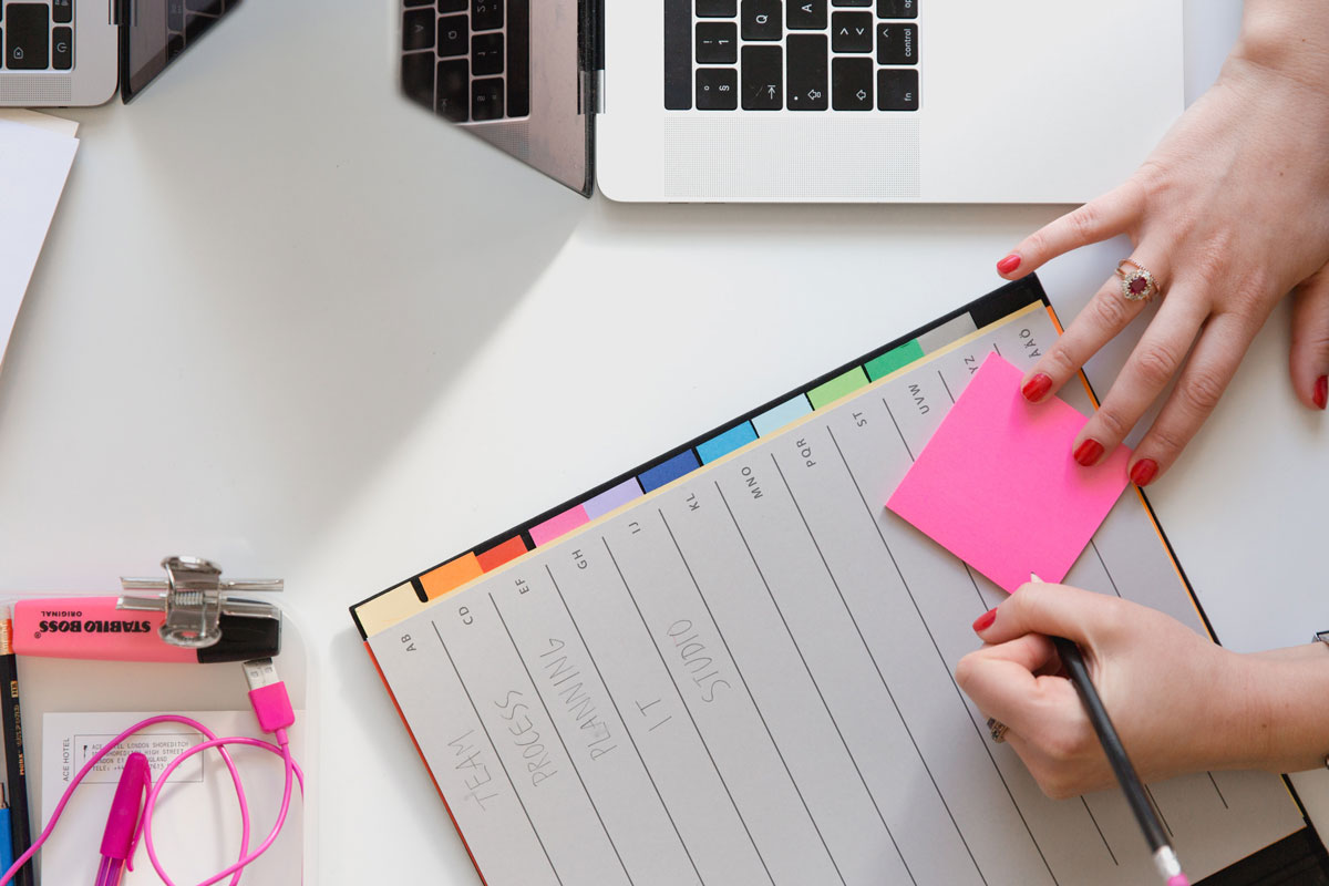 A person writing on sticky notes